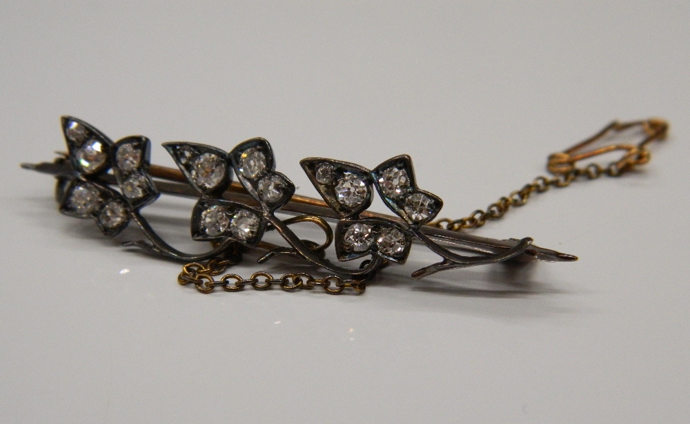 An Edwardian unmarked diamond leaf brooch. 4.5 cm long (3.2 grammes total weight).