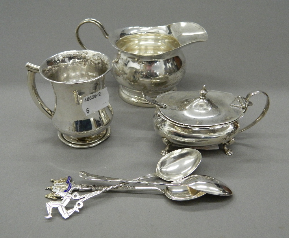 A silver cream jug, a mustard, a mug and spoons (7.