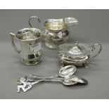 A silver cream jug, a mustard, a mug and spoons (7.