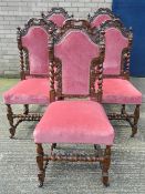 A set of seven Victorian carved oak dining chairs. The carvers 63 cm wide.