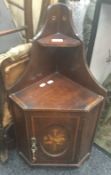 An Edwardian inlaid mahogany hanging corner cupboard. 75 cm high.