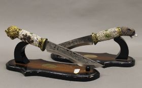 A pair of decorative display hunting knives. Each 33 cm long.