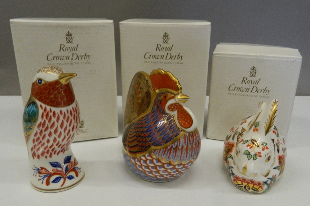 Three boxed Royal Crown Derby paperweights (all with stoppers), including Meadow Rabbit,