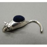 A silver pin cushion in the form of a mouse. 3 cm long.