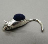 A silver pin cushion in the form of a mouse. 3 cm long.