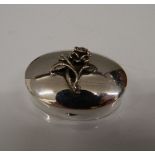 A silver oval pill box. 4 cm wide (16.