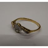 An unmarked gold and diamond ring. Ring size N (1.7 grammes total weight).