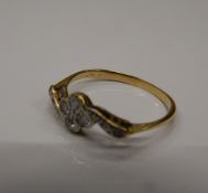 An unmarked gold and diamond ring. Ring size N (1.7 grammes total weight).