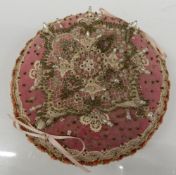 A Victorian beaded pin cushion. 16.5 cm diameter.