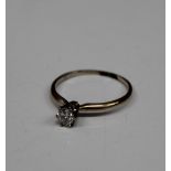 An unmarked gold diamond solitaire ring. Ring size N/O (1.