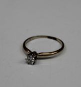 An unmarked gold diamond solitaire ring. Ring size N/O (1.