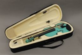 A cased child's violin. 50 cm long.