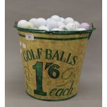 A bucket containing a quantity of golf balls