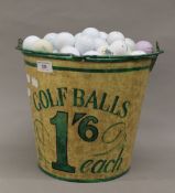 A bucket containing a quantity of golf balls