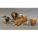 Four Beswick animals, a lion, a cheetah, a kingfisher and a highland cow. The lion 27 cm long.