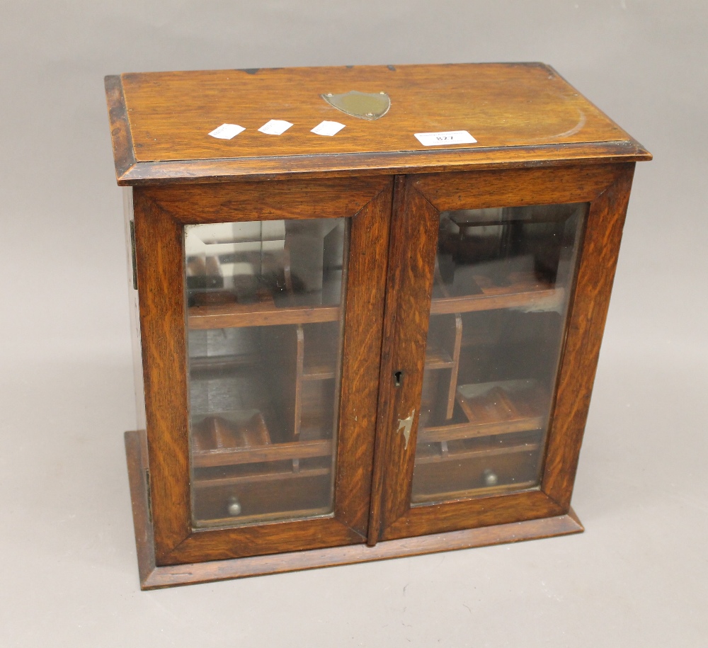 A Victorian oak smokers cabinet. 36 cm wide.