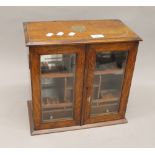 A Victorian oak smokers cabinet. 36 cm wide.