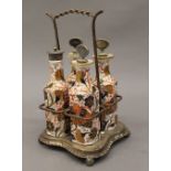 A four bottle silver plated cruet stand, the porcelain bottles decorated in the Imari palette.