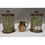 A pair of Royal Doulton lidded pots and a miniature Royal Doulton Shakespeare jug.