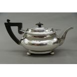 A silver teapot. 13 cm high; 25.