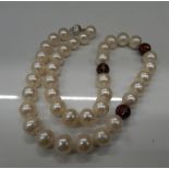 An 18 ct gold pearl and diamond necklace. 47 cm long.