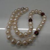 An 18 ct gold pearl and diamond necklace. 47 cm long.