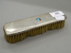 A Liberty and Co Archibald Knox silver brush. 16.5 cm long.