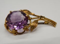 A 9 ct gold and amethyst brooch of floral form. 4.5 cm high (6.