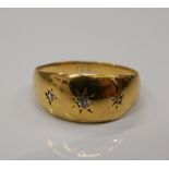 A small 18 ct gold three stone diamond gypsy set ring. Ring size H/I (1.5 grammes total weight).