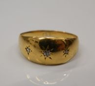 A small 18 ct gold three stone diamond gypsy set ring. Ring size H/I (1.5 grammes total weight).