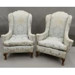 A pair of early 20th century upholstered armchairs. 91 cm wide.