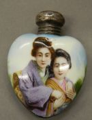 An early 20th century silver mounted heart shaped porcelain scent bottle. 5.5 cm high.