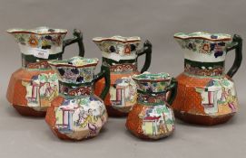 Five Masons Ironstone jugs. The largest 21 cm high.