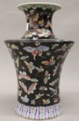 A Chinese famille noir porcelain vase, decorated with butterflies. 30 cm high.