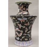 A Chinese famille noir porcelain vase, decorated with butterflies. 30 cm high.