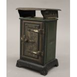 A Wright's Eureka No.410 gas stove oven tinplate money box. 13 cm high.
