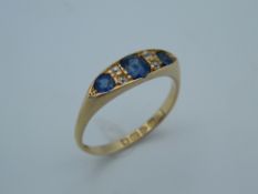 An 18 ct yellow gold sapphire and diamond ring, with Chester hallmarks. Ring size R (3.