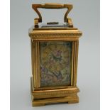 A porcelain and silver gilt case miniature carriage clock. 10 cm high.
