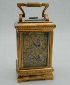 A porcelain and silver gilt case miniature carriage clock. 10 cm high.