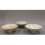 An 18th/19th century Chinese celadon glazed bowl with incised decoration, together with two others.