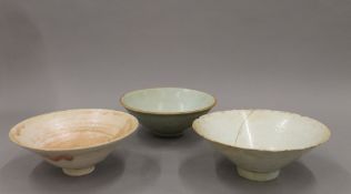 An 18th/19th century Chinese celadon glazed bowl with incised decoration, together with two others.