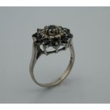 An 18 ct white gold diamond and sapphire ring. Ring size N (4.