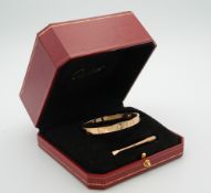 A Cartier four stone diamond set 18 ct gold love bracelet, signed,