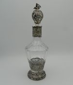 A Continental silver and cut glass decanter and stopper, the silver applied with figures,