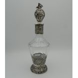 A Continental silver and cut glass decanter and stopper, the silver applied with figures,