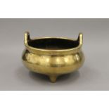 A finely cast 19th century Chinese two handled bronze incense burner on three short feet,