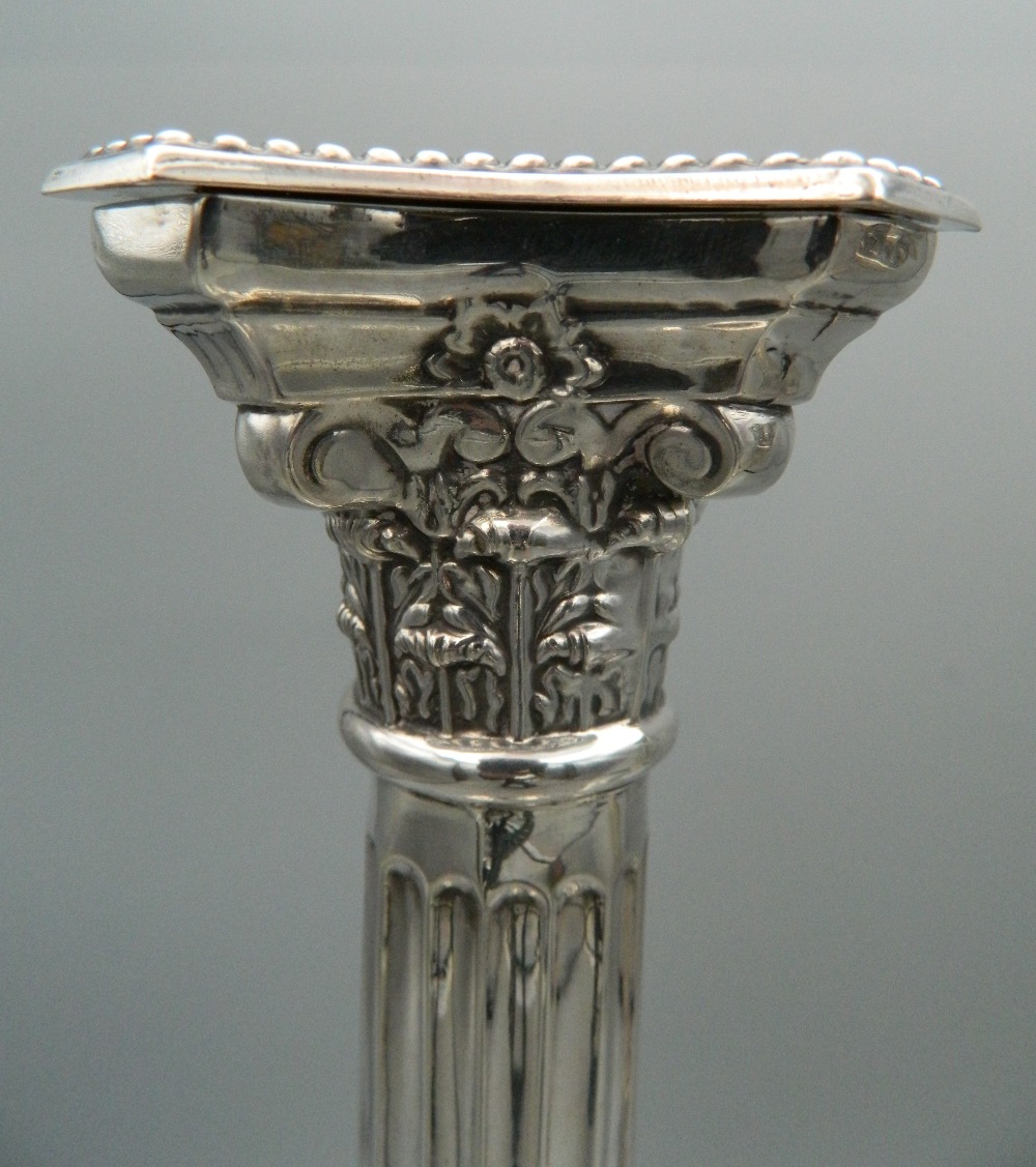 A pair of hallmarked English silver Corinthian column candlesticks. One sconce lacking. 31 cm high. - Image 2 of 8