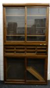 A mid-20th century haberdashery unit. 122 cm wide, 221 cm high.