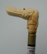 A bone carved walking stick formed as a dog. 94.5 cm long.