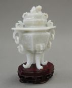 A Chinese jade vase and cover, with stand. 16 cm high overall.